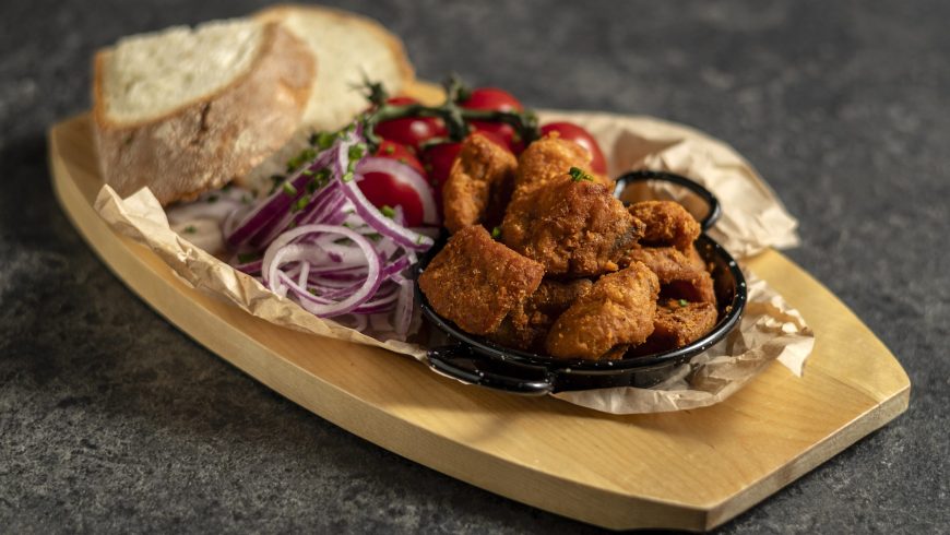 Paprikás mangalica crackling with red onion and rustic bread