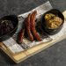 Spicy baked sausage with stewed cabbage and potato mash with fried onion