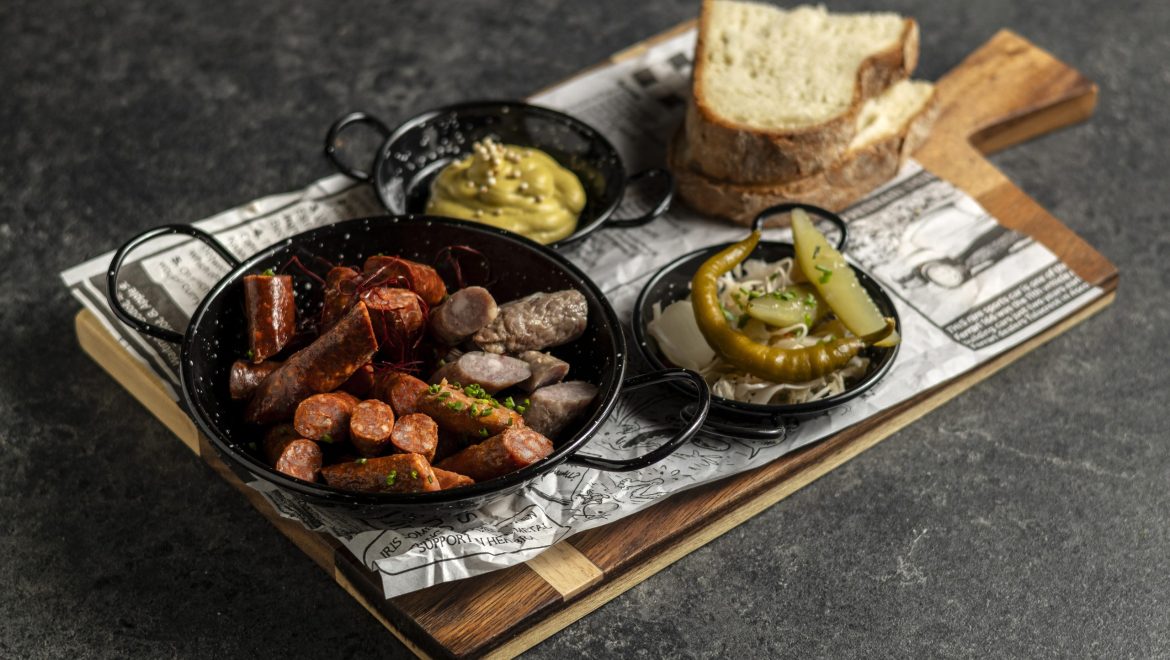 Cold sausage selection with homemade pickles and mustard